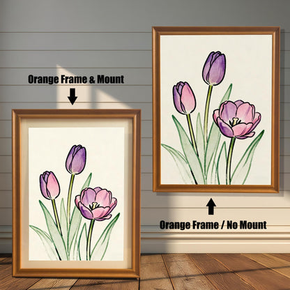 Comparison of two framed art prints on a wall. On the left, a watercolor-style print of pink and purple tulips in a framed with an Orange Frame & Mount (matting). On the right, the same art print with an Orange Frame / No Mount. Arrows indicate the frame/mount options.