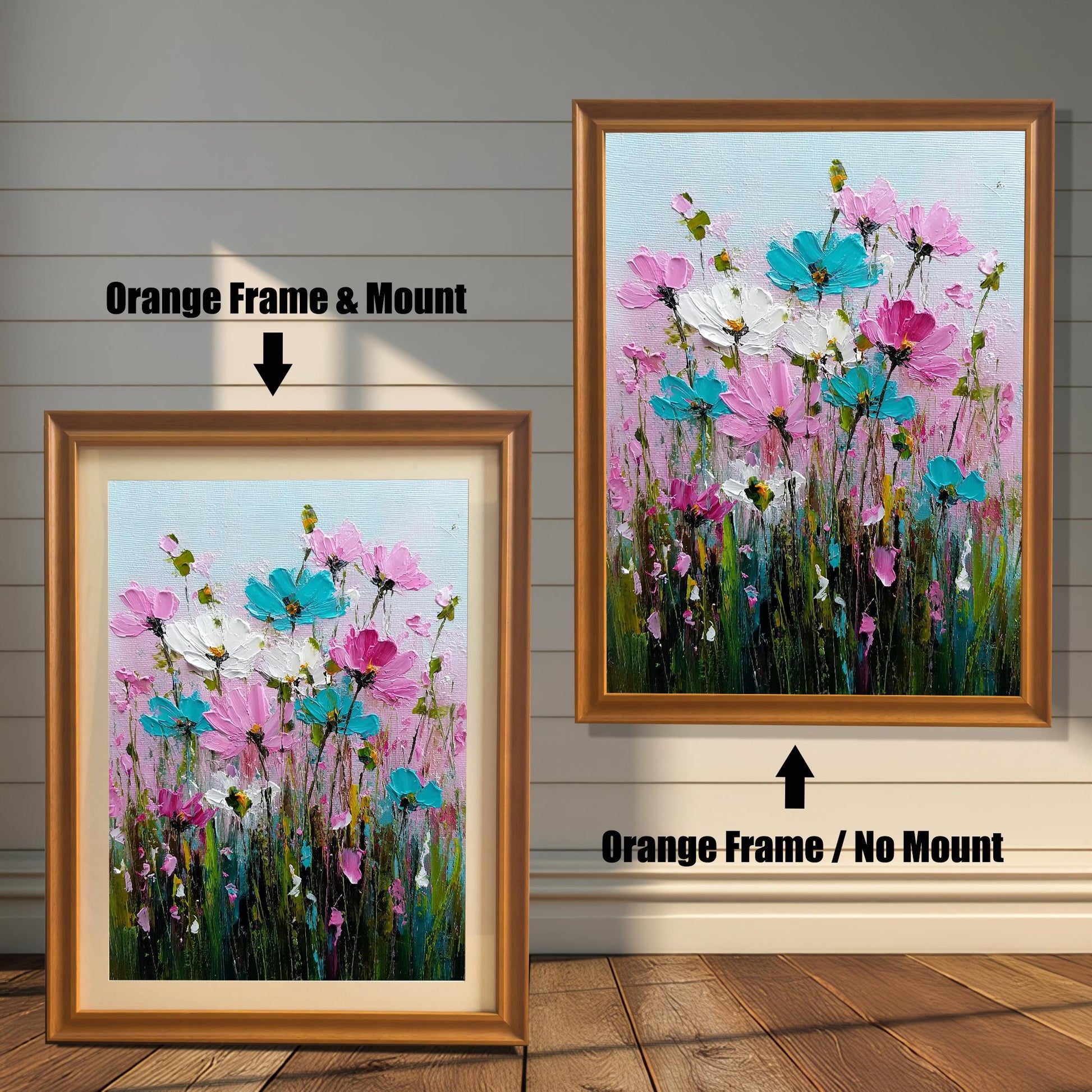 Product image comparing two options: an Orange Frame & Mount (with a light mat) and an Orange Frame / No Mount for the colorful wildflower painting print. The framed prints are displayed on a wood floor against a white, shiplap wall.