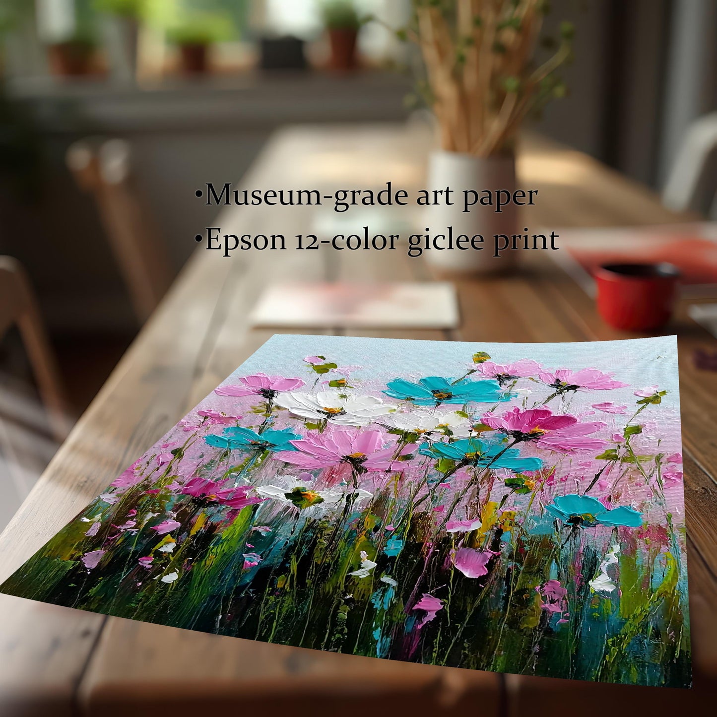Close-up of an unframed art print of the pink and teal flower painting, highlighting the product quality: Museum-grade art paper and Epson 12-color giclee print. The print is leaning on a rustic wooden table.