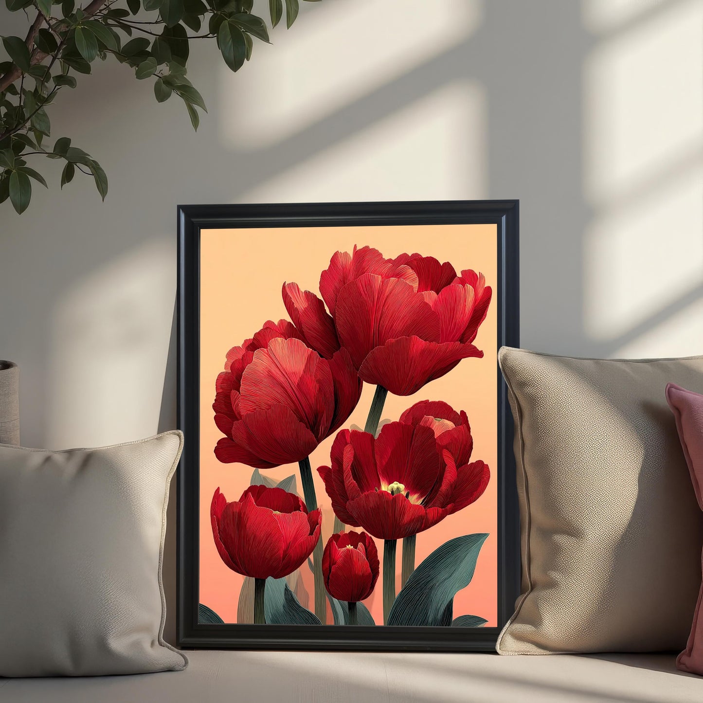 A close-up lifestyle shot of the red tulip art print in a Black Frame (No Mount). The framed art is leaning on a white bench, nestled between two beige throw pillows, with sunlight casting plant shadows.