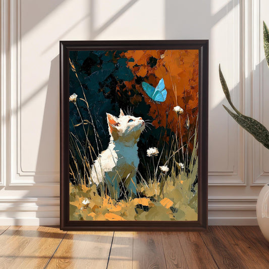 The art print featuring a white cat and blue butterfly, displayed in a Coffee-colored wood frame, resting on a wooden floor against a sunlit white paneled wall next to a large potted plant.
