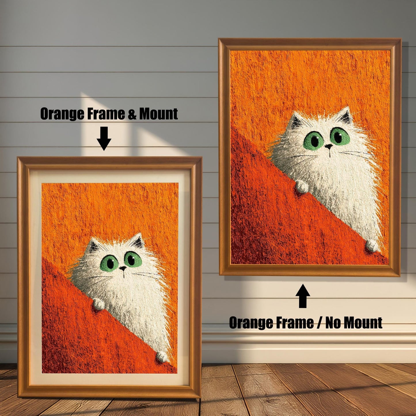 Two framed prints of the white cat on a rustic wood-paneled floor and wall. The left shows an Orange Frame & Mount (matting), and the right shows an Orange Frame / No Mount.