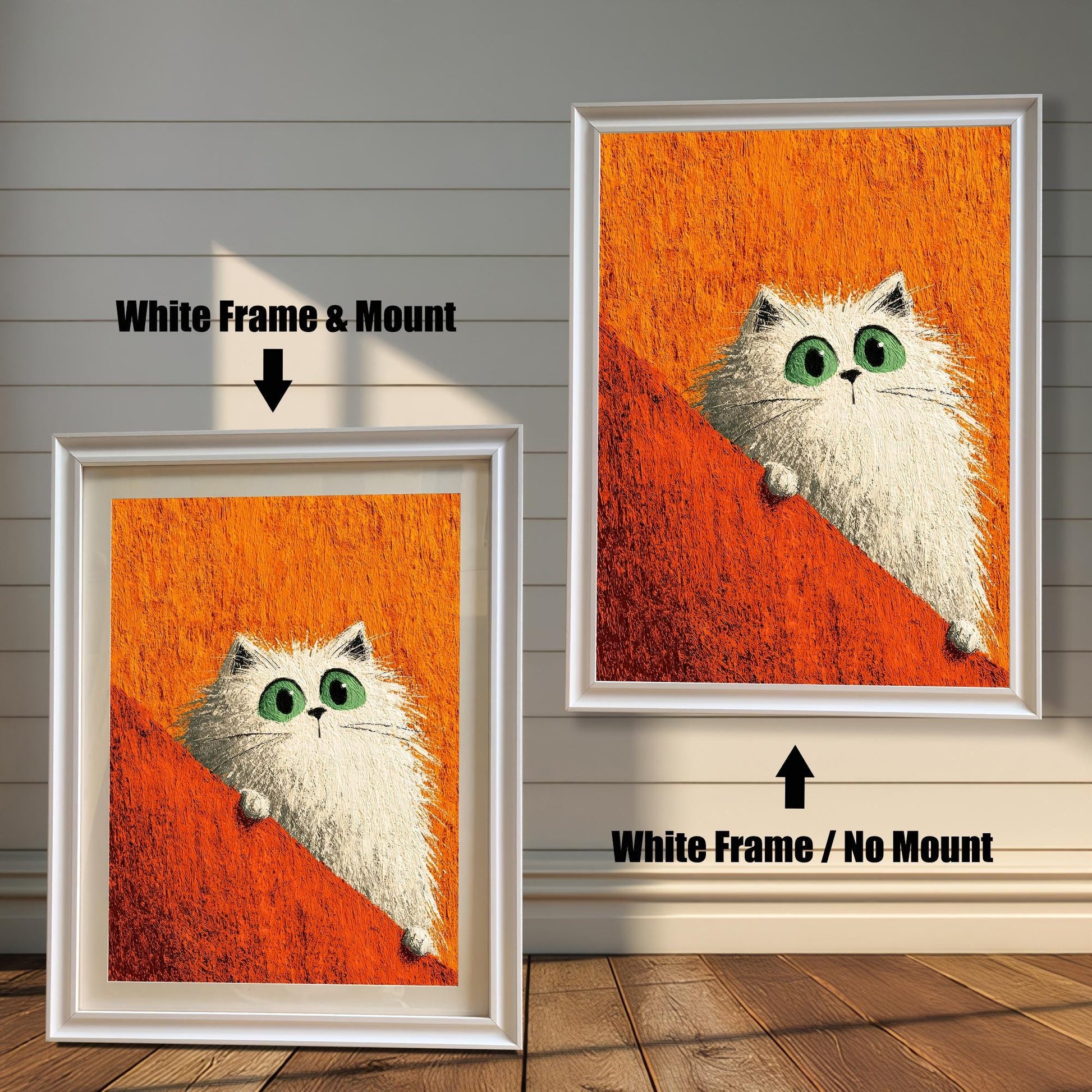 Two framed prints of the white cat on a rustic wood-paneled floor and wall. The left shows a White Frame & Mount (matting), and the right shows a White Frame / No Mount.