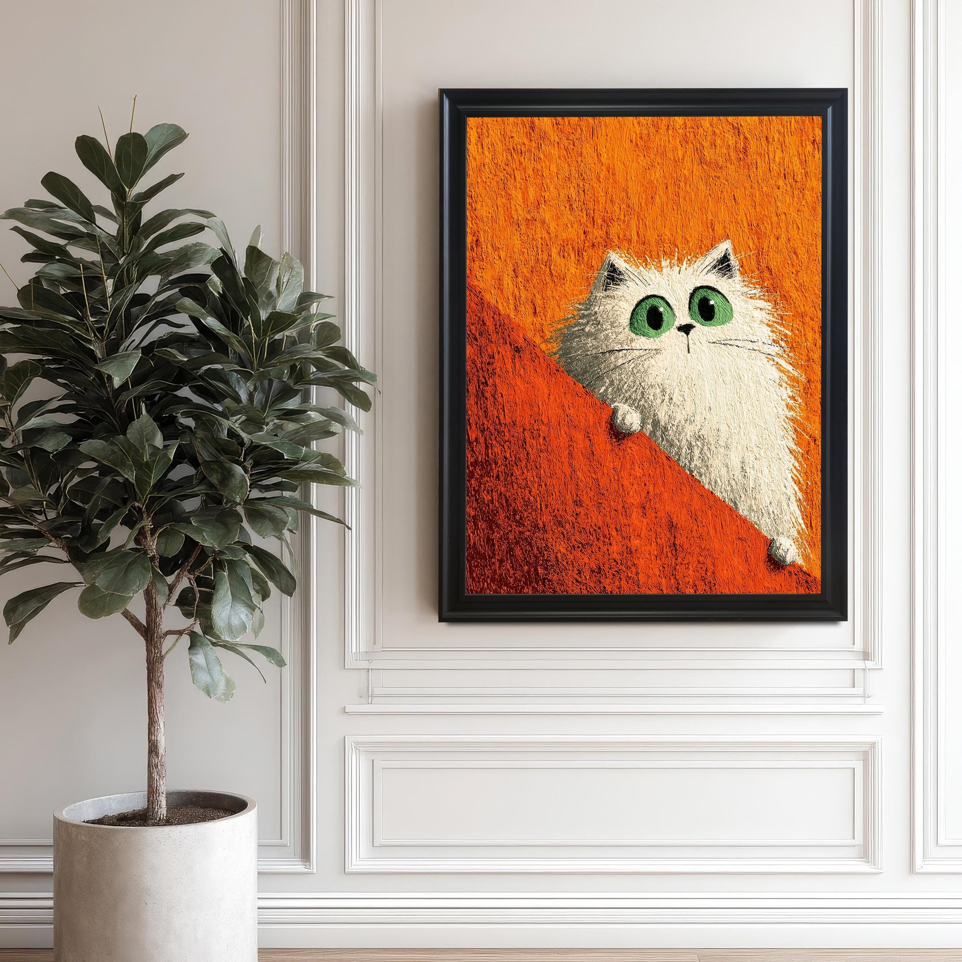 Framed print of a fluffy white cat with green eyes against an orange background, hanging on a white wall with decorative molding next to a large potted plant. The print is in a Black wood frame.