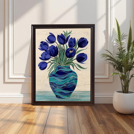 Framed print of dark blue tulips in a swirling turquoise vase resting on a wood floor against a white paneled wall next to a potted snake plant. The frame is Coffee-colored wood.