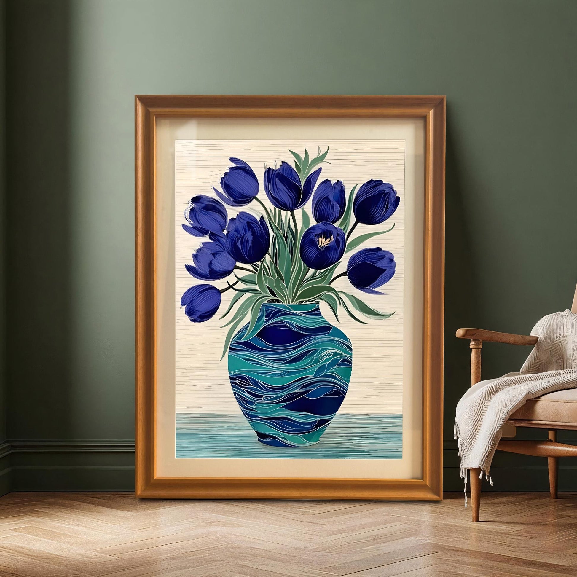 Large framed print of the blue tulips in a decorative teal vase resting on a wood floor against a dark green wall, next to a wooden armchair. The frame is Orange-colored wood.