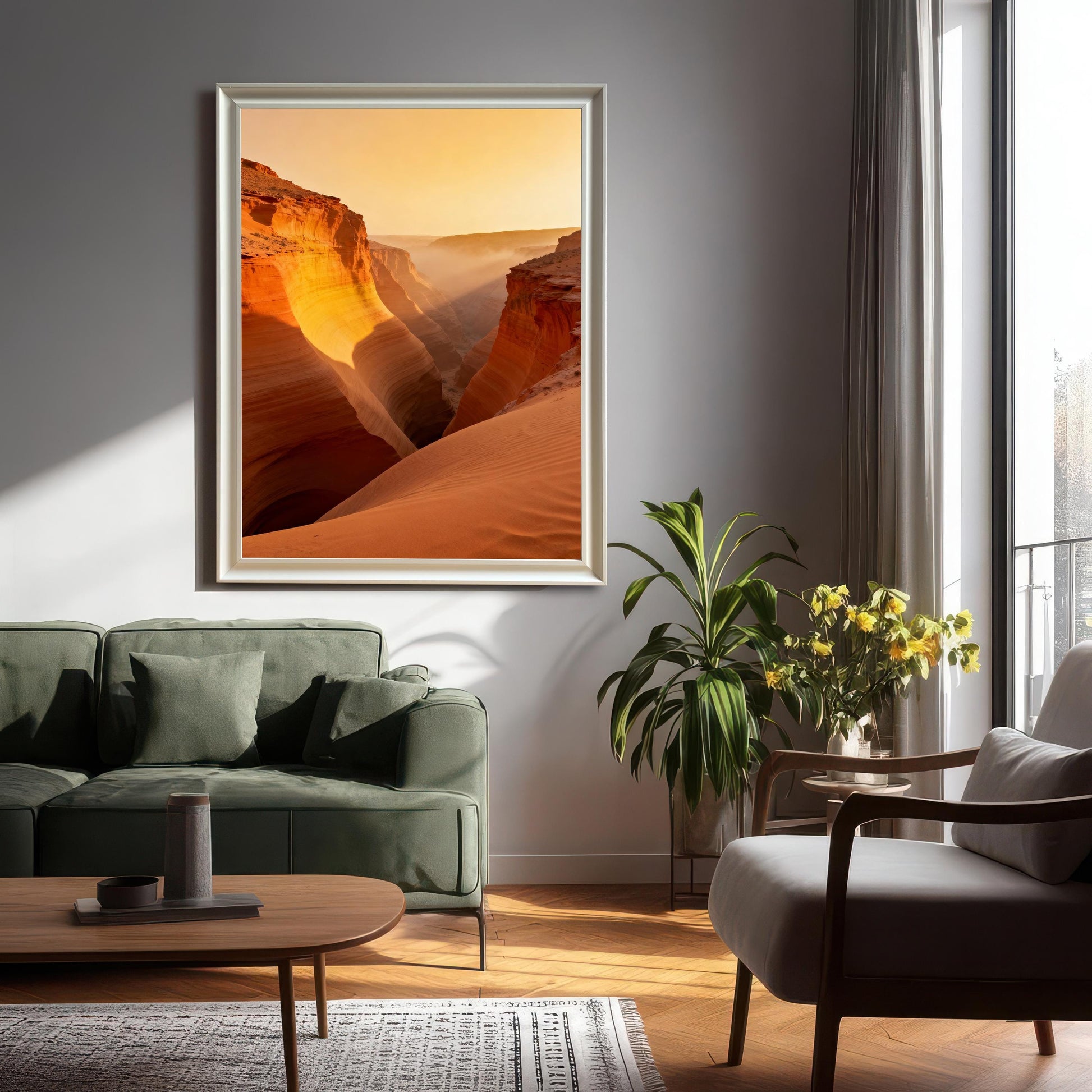 Large framed print of the vibrant canyon with mist and sunlight hanging on a light grey wall in a living room setting with a green sofa and plant. The frame is White-colored wood.