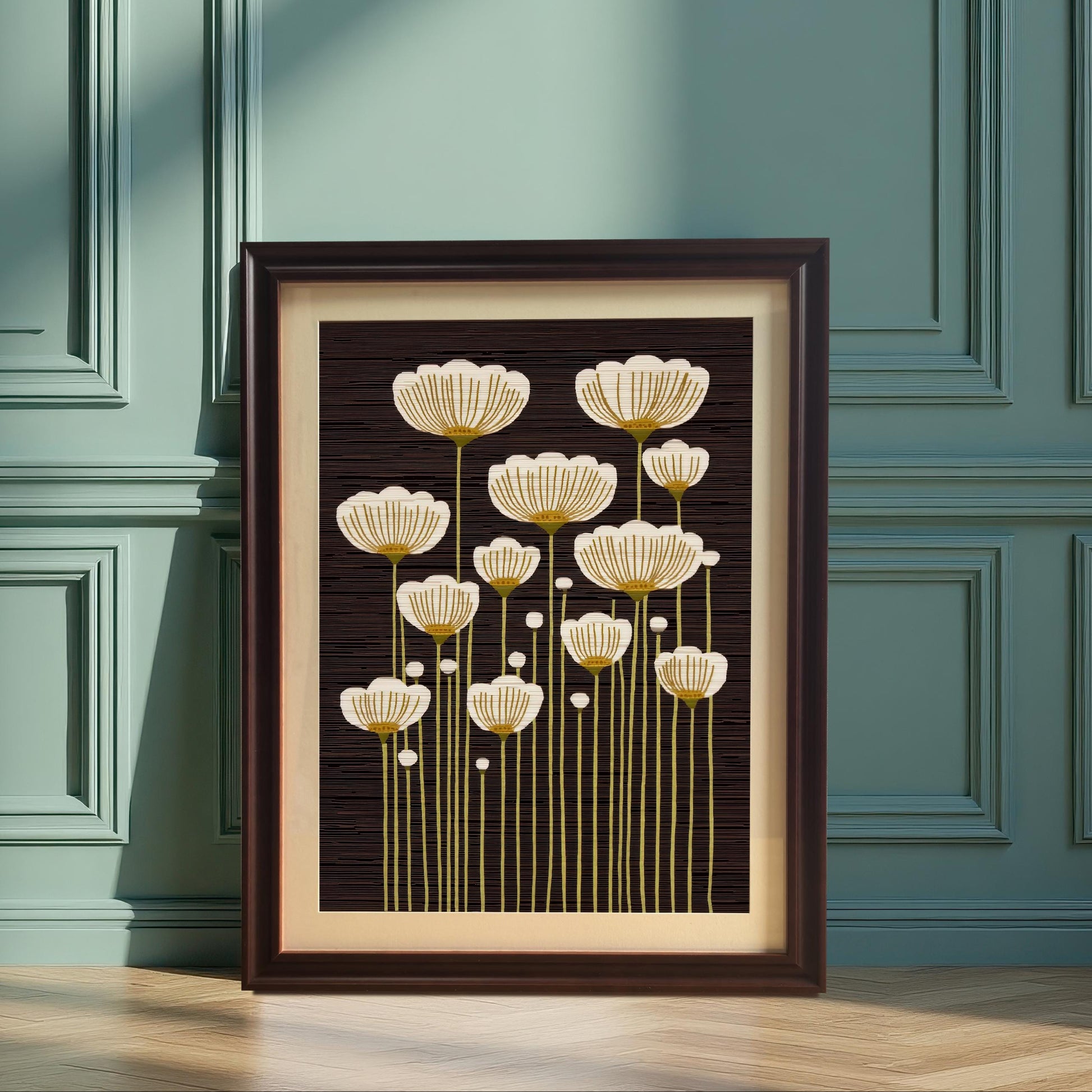 Coffee framed art print of abstract white and gold flowers, leaning on the floor against a green paneled wall in a sunlit room.