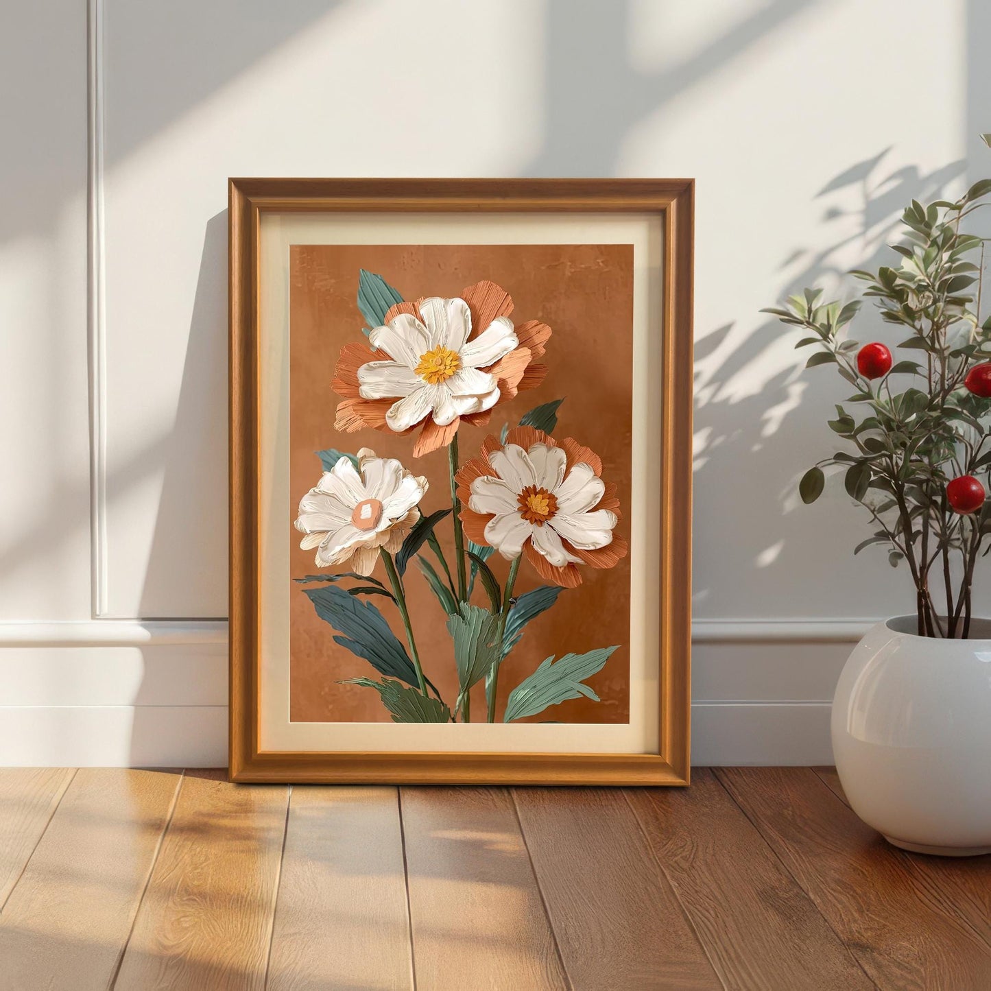 Lifestyle photo of the art print in an Orange wood frame with a mat/mount, leaning on a light wooden floor against a white wall next to a decorative potted plant with red berries.