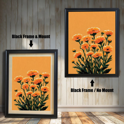 Two framed orange floral art prints against a light wood panel wall and wood floor. The print on the left has a Black Frame & Mount (matting). The print on the right has a Black Frame / No Mount.