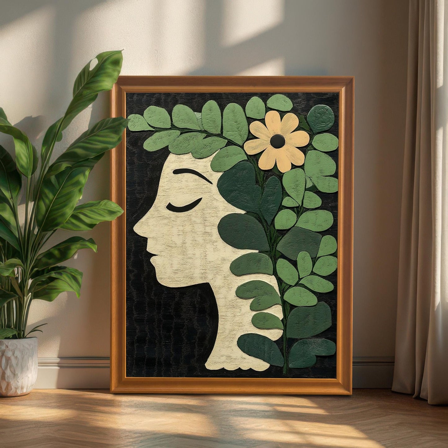 A portrait-oriented botanical profile art print in an Orange/Wood-tone frame leaning on the floor against a wall, next to a large potted green plant and curtain.