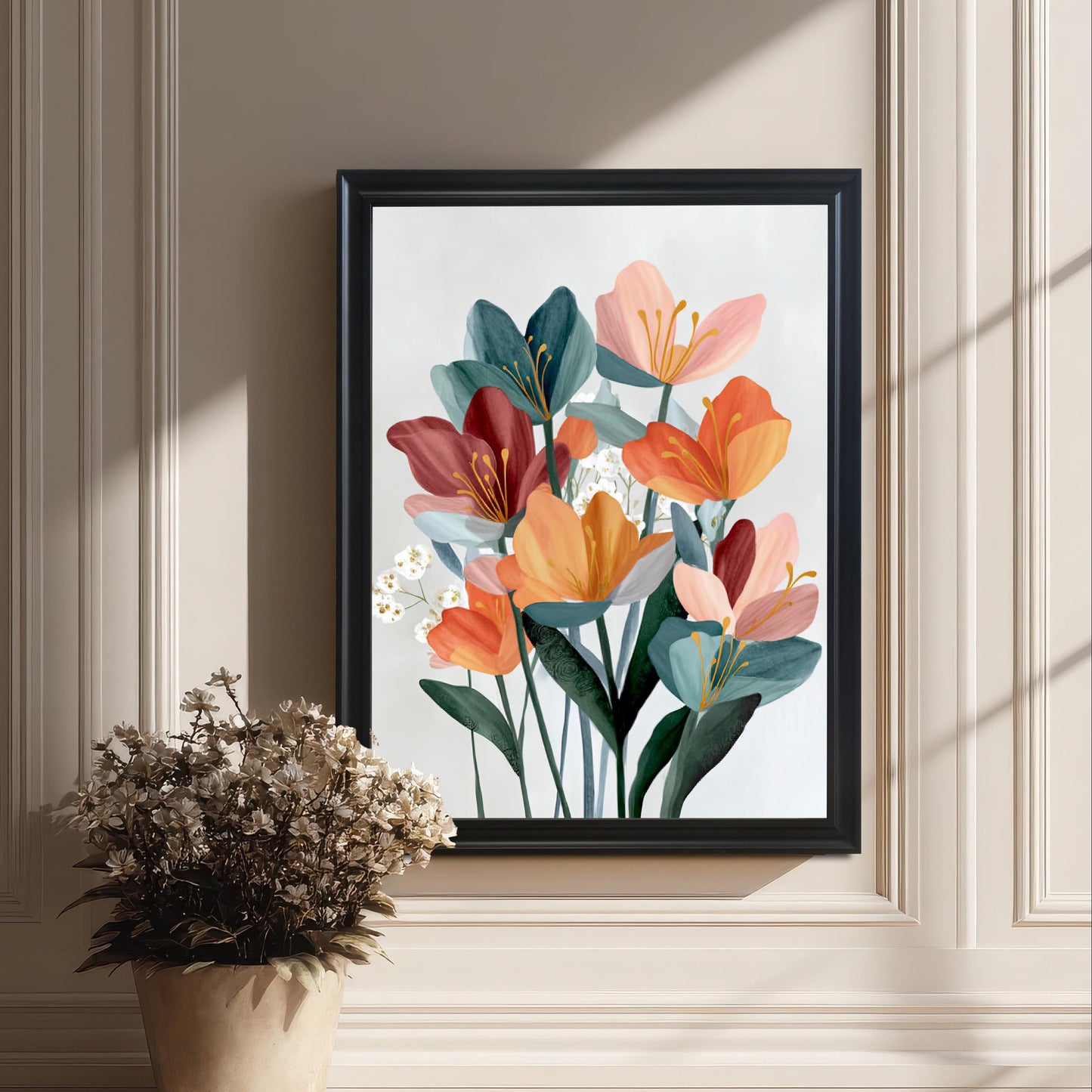 Framed abstract floral art print in a black frame leaning on the floor against an elegant white wainscoted wall, next to a decorative pot of dried flowers.