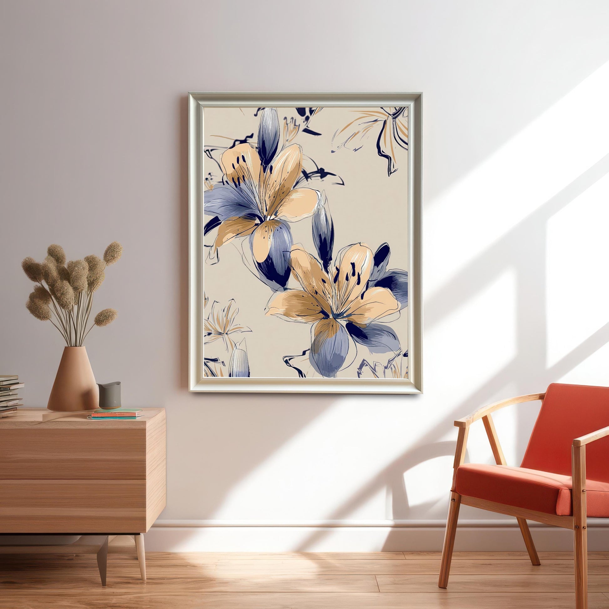 Large framed print of the Navy Blue and Peach/Gold Lily artwork in a silver/light gold frame without a mat/mount, hanging on a light wall in a modern room with a wooden side table and an orange chair.