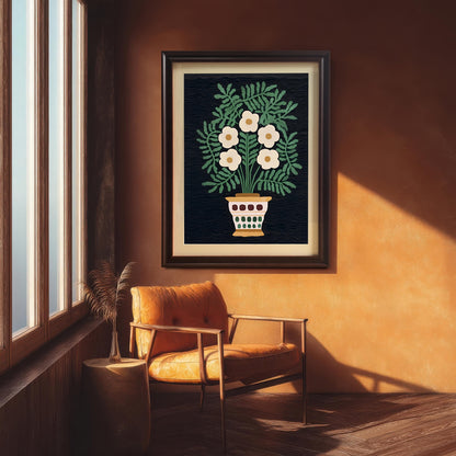 The folk art floral print hangs on a dark orange-brown textured wall, framed in a Dark Coffee Frame. The art is situated above a wooden chair with an orange leather cushion next to a large window, showing a cozy, autumnal aesthetic.