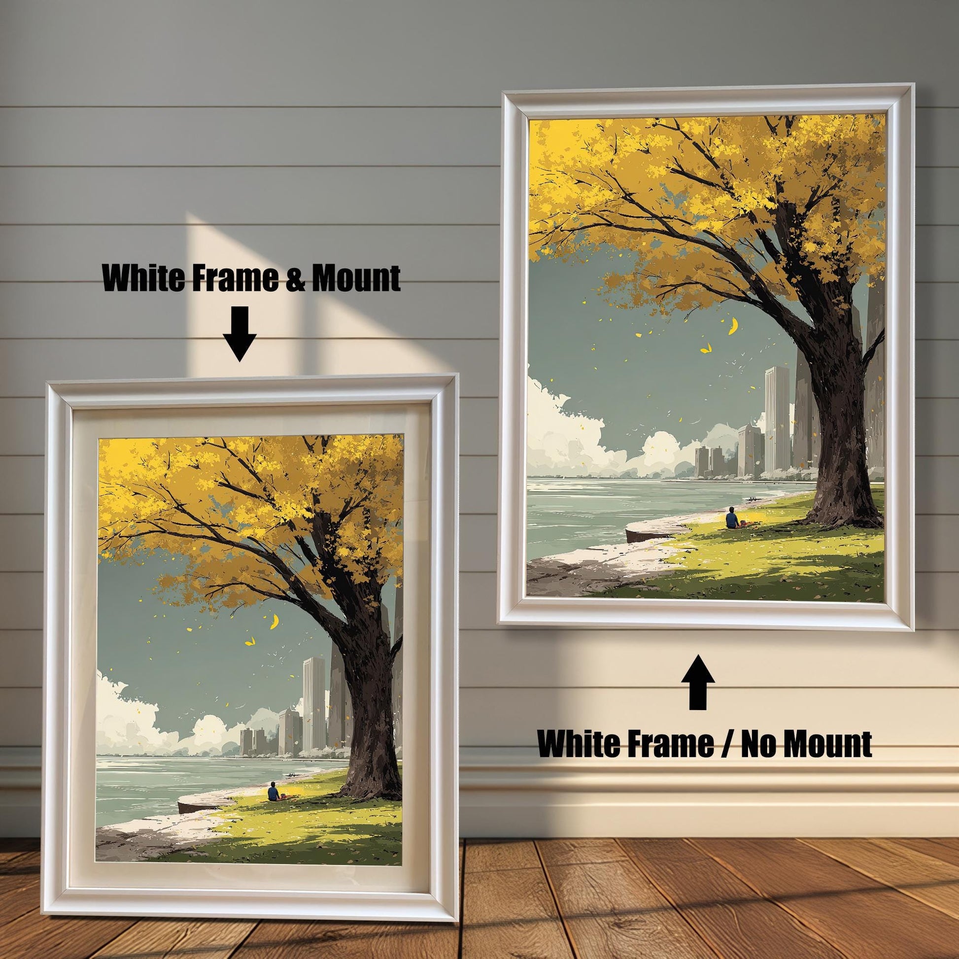 Yellow autumn tree art print comparison showing two framing options: White Frame & Mount (with a cream border) and White Frame / No Mount. The scene features a solitary figure near the water with a city skyline backdrop.