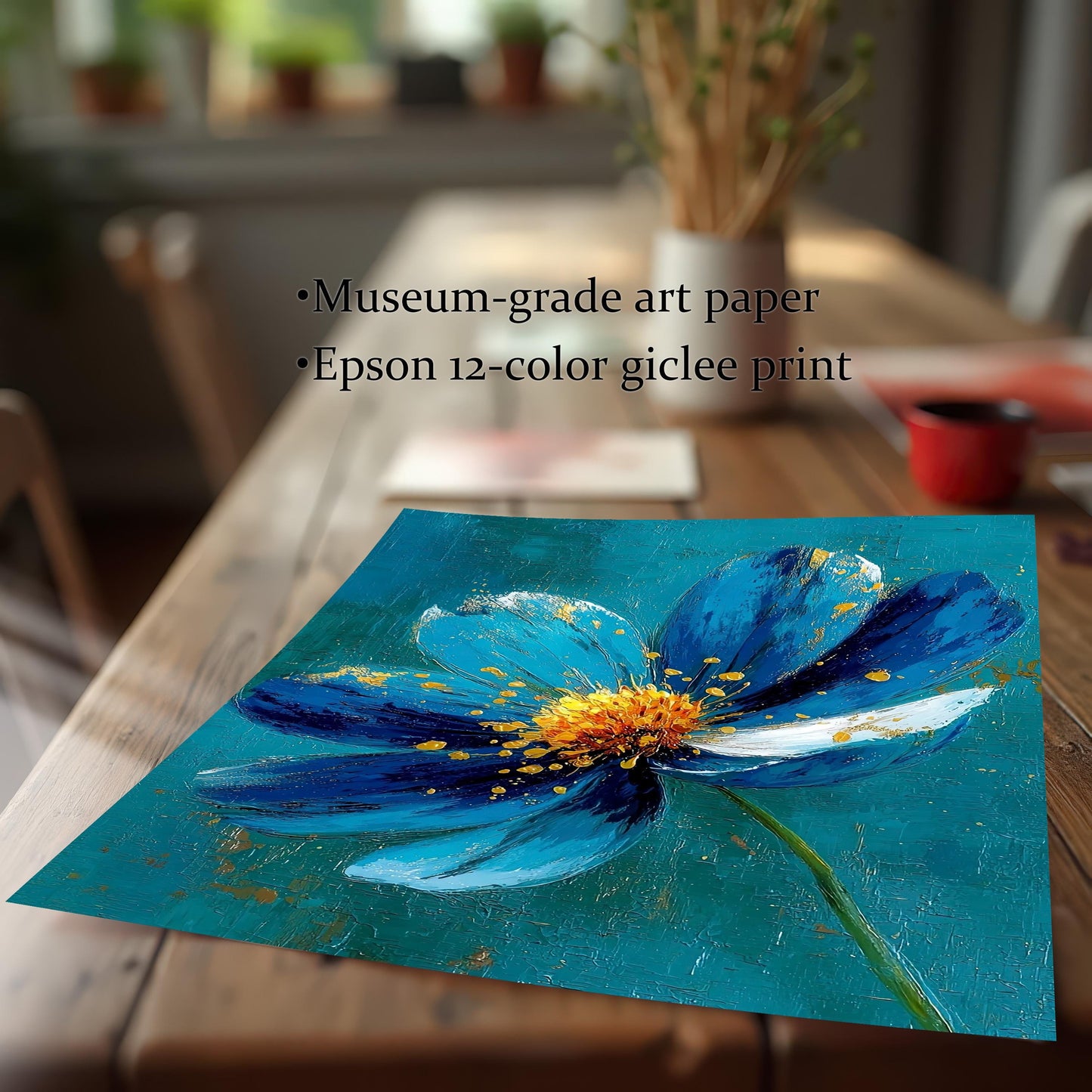 The art print of a blue and gold flower lying on a wooden table. Text overlay highlights: ""Museum-grade art paper"" and ""Epson 12-color giclee print""