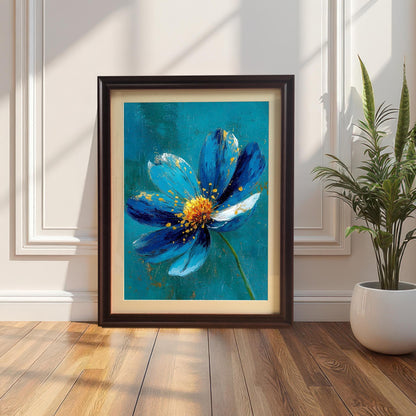 A framed art print of a striking blue flower with gold accents, set in a Coffee-colored frame with a mount (mat). The print is leaning on a wood floor against a white paneled wall next to a houseplant.