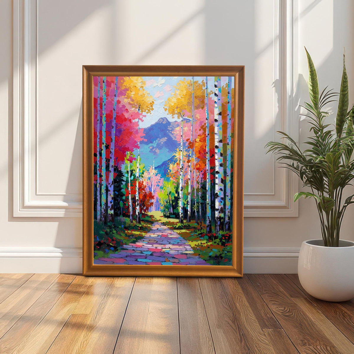 Full view of the Impasto Aspen Forest art print in an Orange Wood Frame, propped on a wooden floor against a white wainscoting wall, next to a houseplant.
