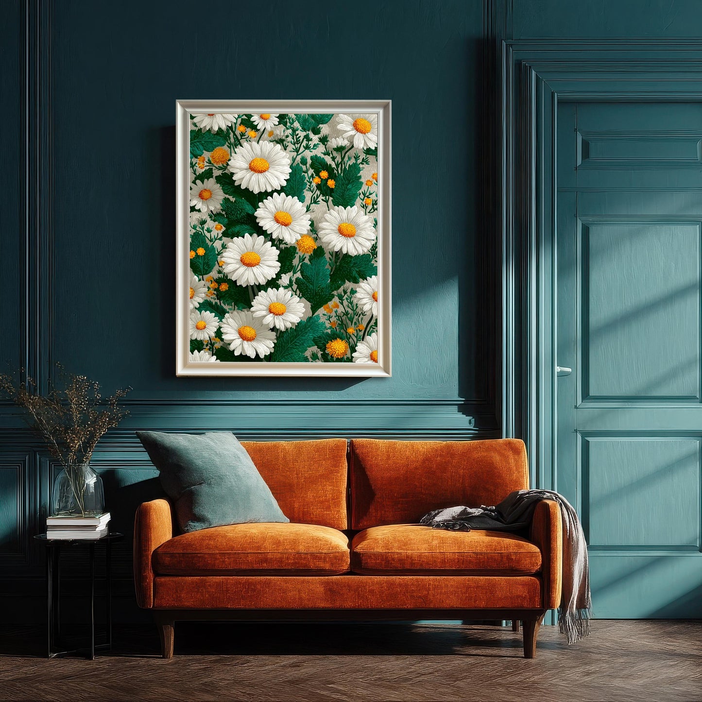 Framed daisy art print with a white/cream wood frame hanging above a vibrant orange velvet loveseat against a dramatic dark teal, paneled wall. This shows the floral art styled in a sophisticated interior setting.