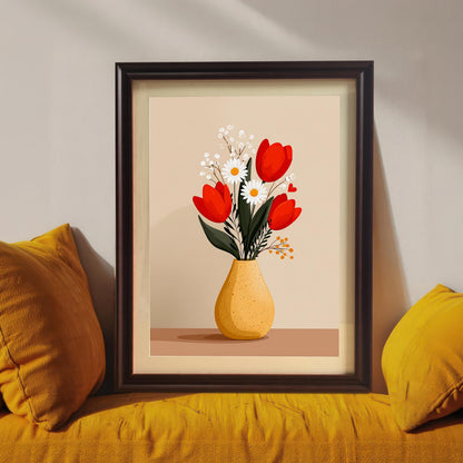 Close-up view of the framed 'Tulips and Daisies in a Yellow Vase' art print. The print is in a Coffee (dark brown/black) wood frame with a mount and rests on a yellow cushion between two pillows.
