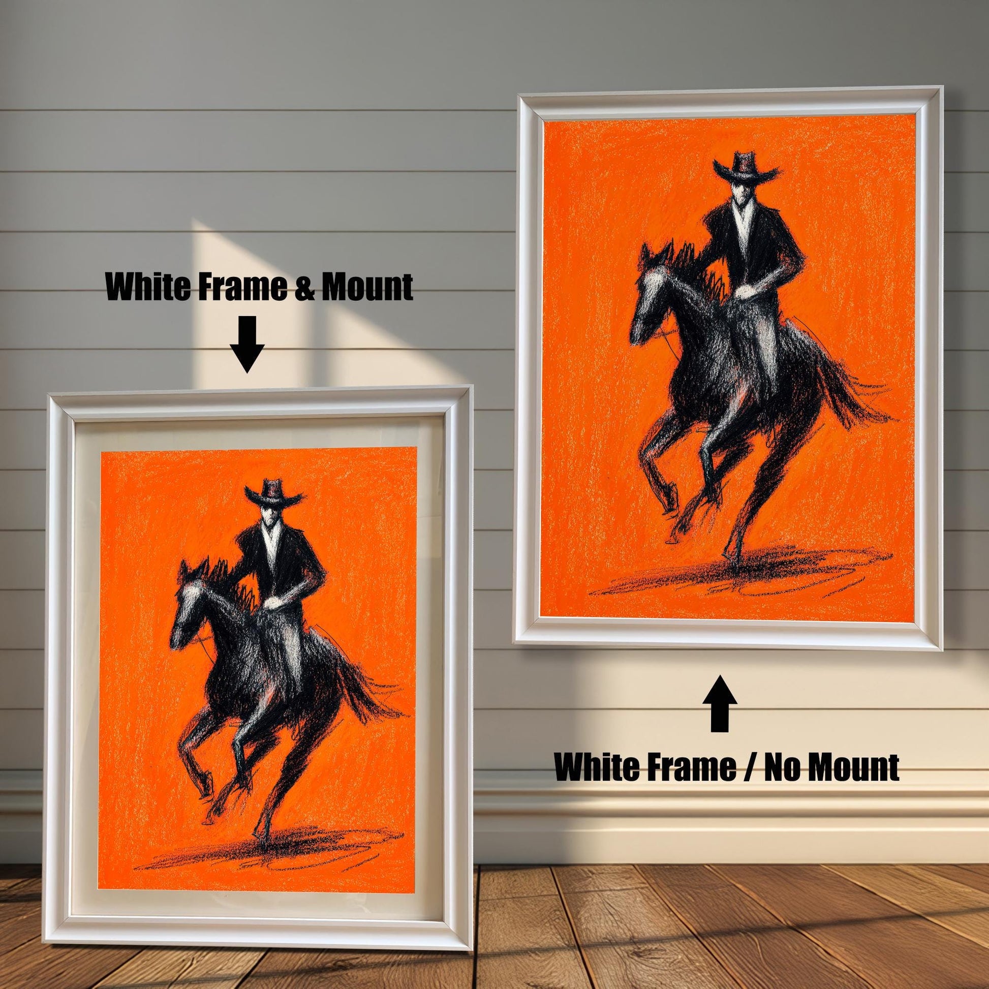 Close-up view of a framed art print featuring a striking black charcoal sketch of a cowboy riding a horse against a bright orange background. The image shows two frame options: a White wood frame with a mount (matting) and a White wood frame with no mount around the print.