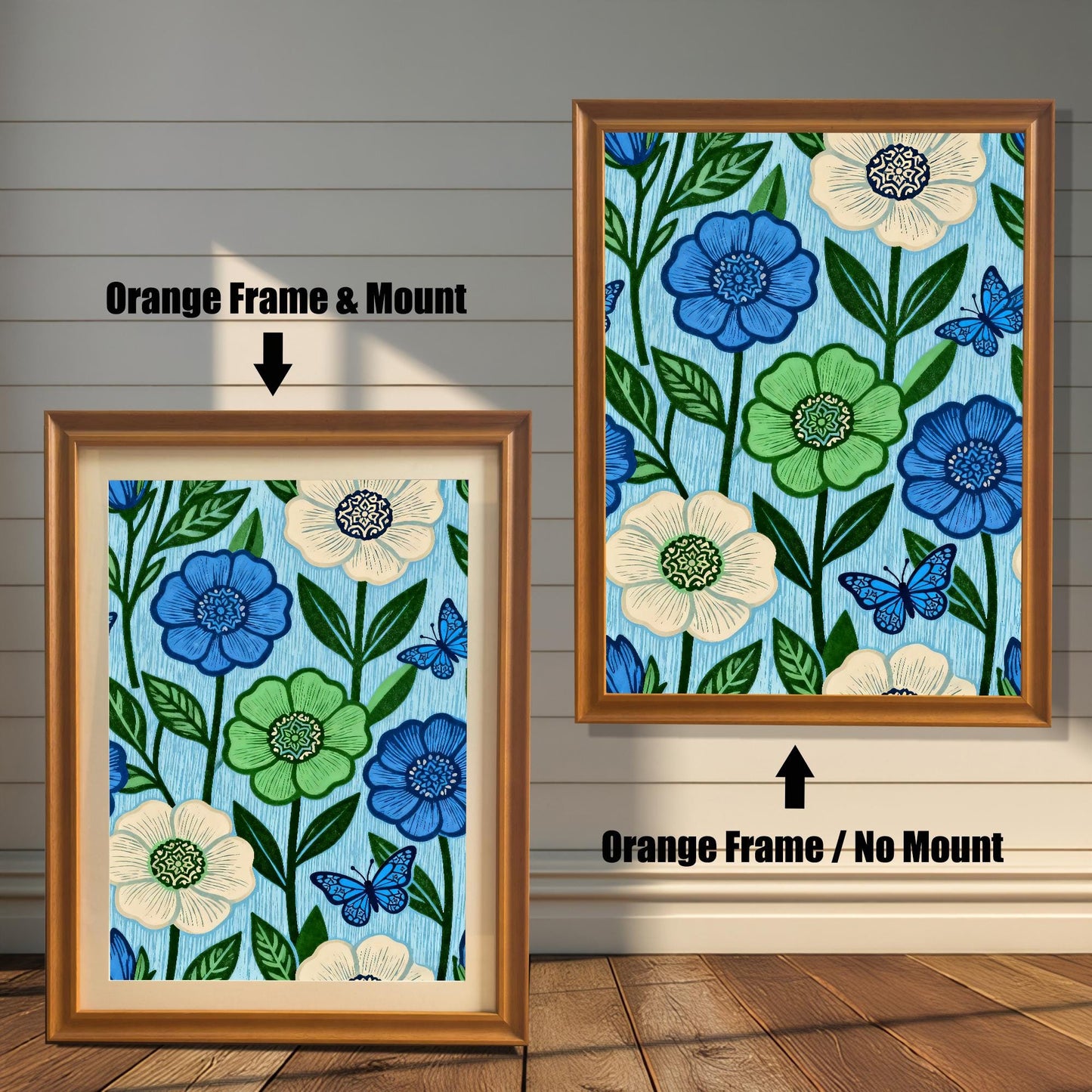 Comparison image showing a golden-brown Orange framed art print with a light-colored mount (mat) on the left, and an Orange framed art print without a mount on the right. Both prints feature a repeating pattern of blue, green, and cream flowers with blue butterflies on a light blue, wood-grain textured background.