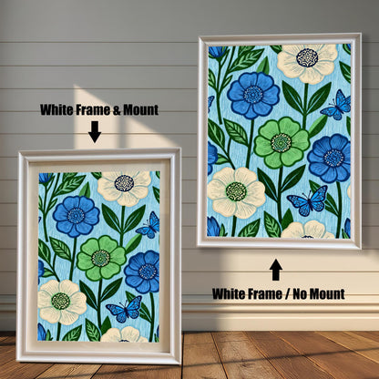 Comparison image showing a White framed art print with a light-colored mount (mat) on the left, and a White framed art print without a mount on the right. Both prints feature a repeating pattern of blue, green, and cream flowers with blue butterflies on a light blue, wood-grain textured background.