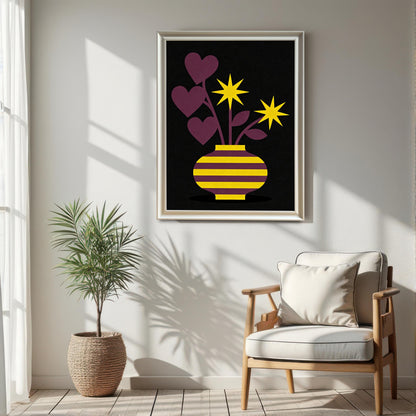 A large White framed art print featuring a yellow and purple striped vase with purple heart-shaped leaves and bright yellow star flowers on a black background. The print is hanging on a white wall in a sunlit room above a light wood chair and next to a potted palm in a woven basket.