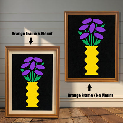 Comparison image showing a golden-brown Orange framed art print with a light-colored mount (mat) on the left, and an Orange framed art print without a mount on the right. Both prints feature a yellow vase with purple and green flowers on black.