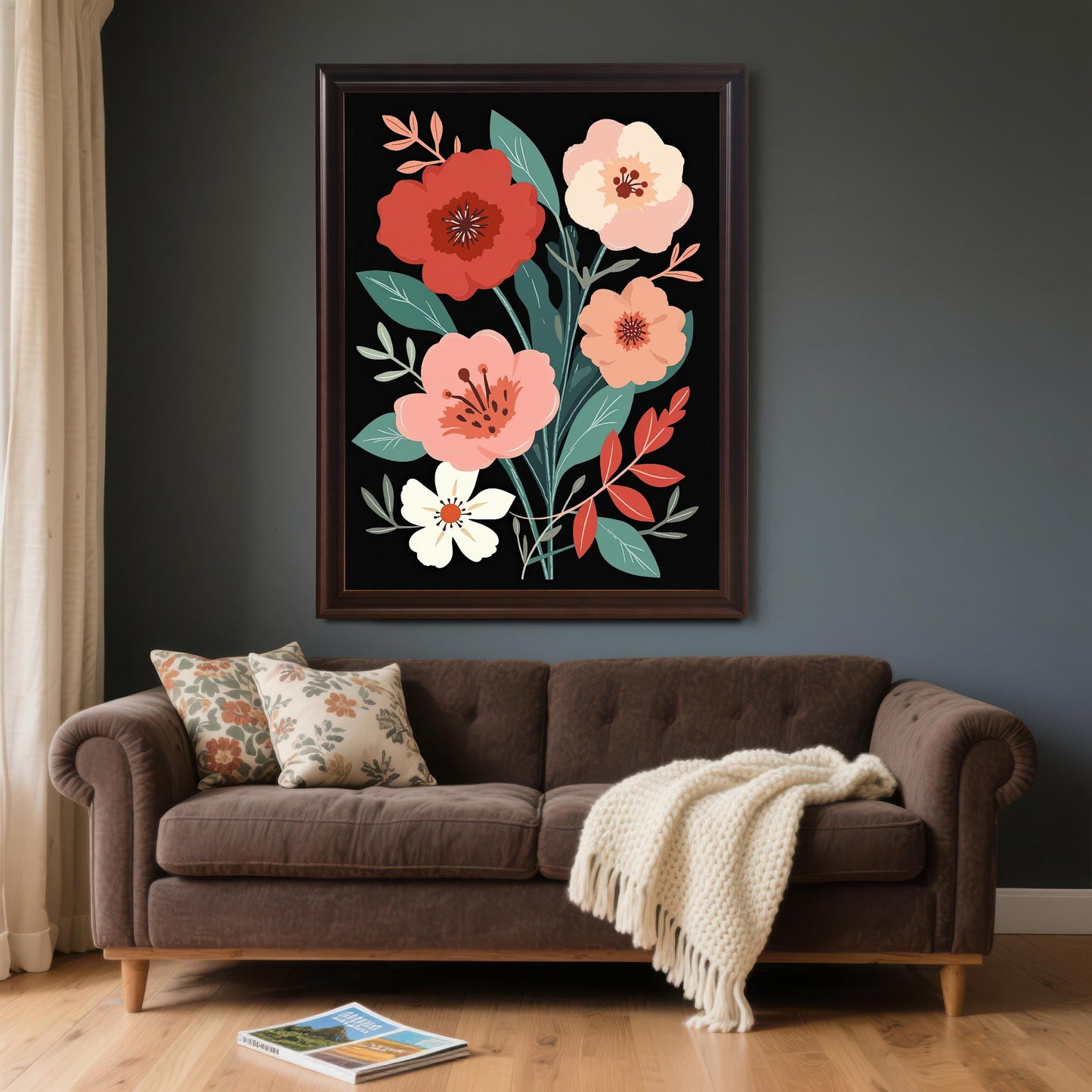 Large floral art print with a dark brown (coffee) frame and no mount (mat), hanging above a brown, tufted sofa with throw pillows and a cream-colored blanket. The wall is painted a dark gray or charcoal color.
