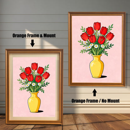 View of the tulip wall art framed in Orange (light brown/gold). Two options are shown: on the left, an Orange Frame & Mount (with a white border/mat) and on the right, an Orange Frame / No Mount (edge-to-edge print). The art features red tulips and daisies in a yellow vase on a pink background.