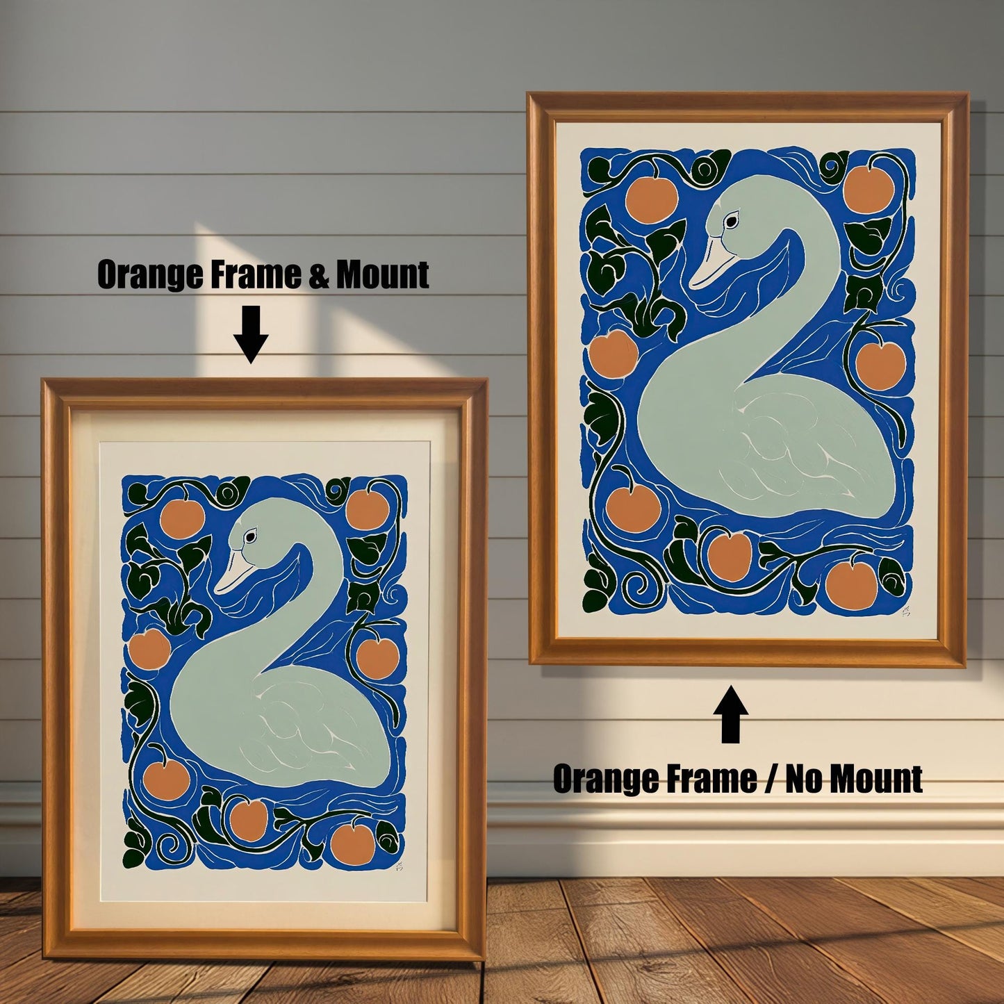 Two framed prints of the swan artwork against a white wooden plank wall. The print on the left is an Orange Frame & Mount, showing the white border. The print on the right is an Orange Frame / No Mount.