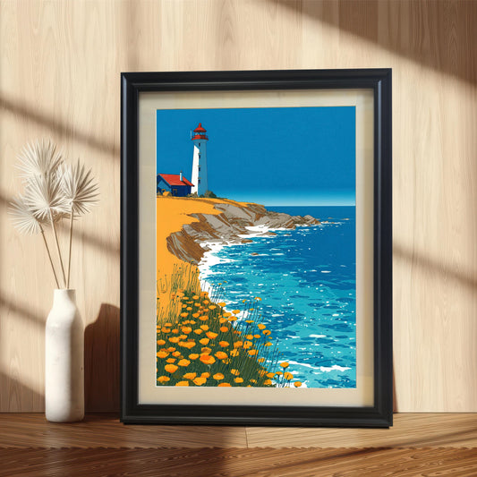 A framed art print of the lighthouse illustration, set in a Black Frame with a light-colored mount, leaning against a light wood-paneled wall next to a white vase with decorative dried foliage.