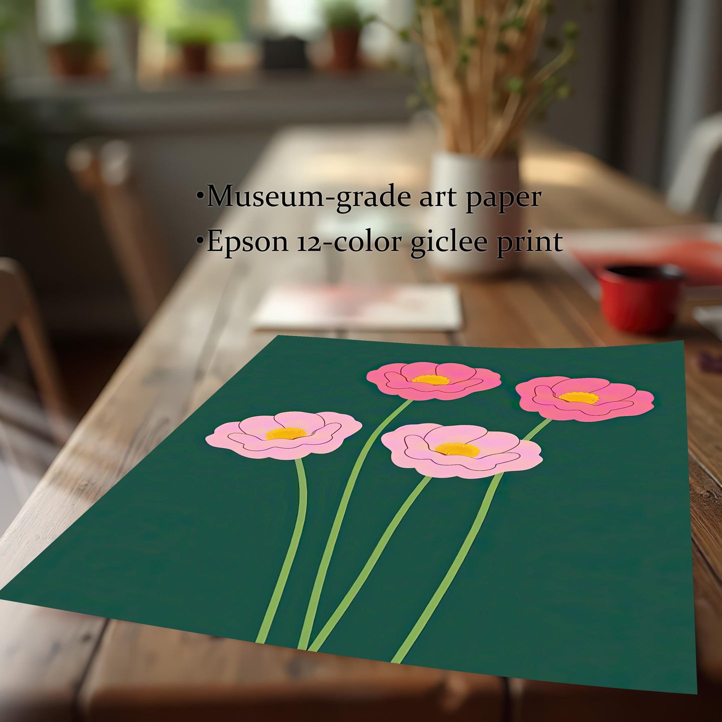Close-up of the art print featuring four stylized pink flowers with yellow centers on light green stems, set against a dark forest green background. The print is lying on a wooden table. Text overlays state: "Museum-grade art paper" and "Epson 12-color giclee print."