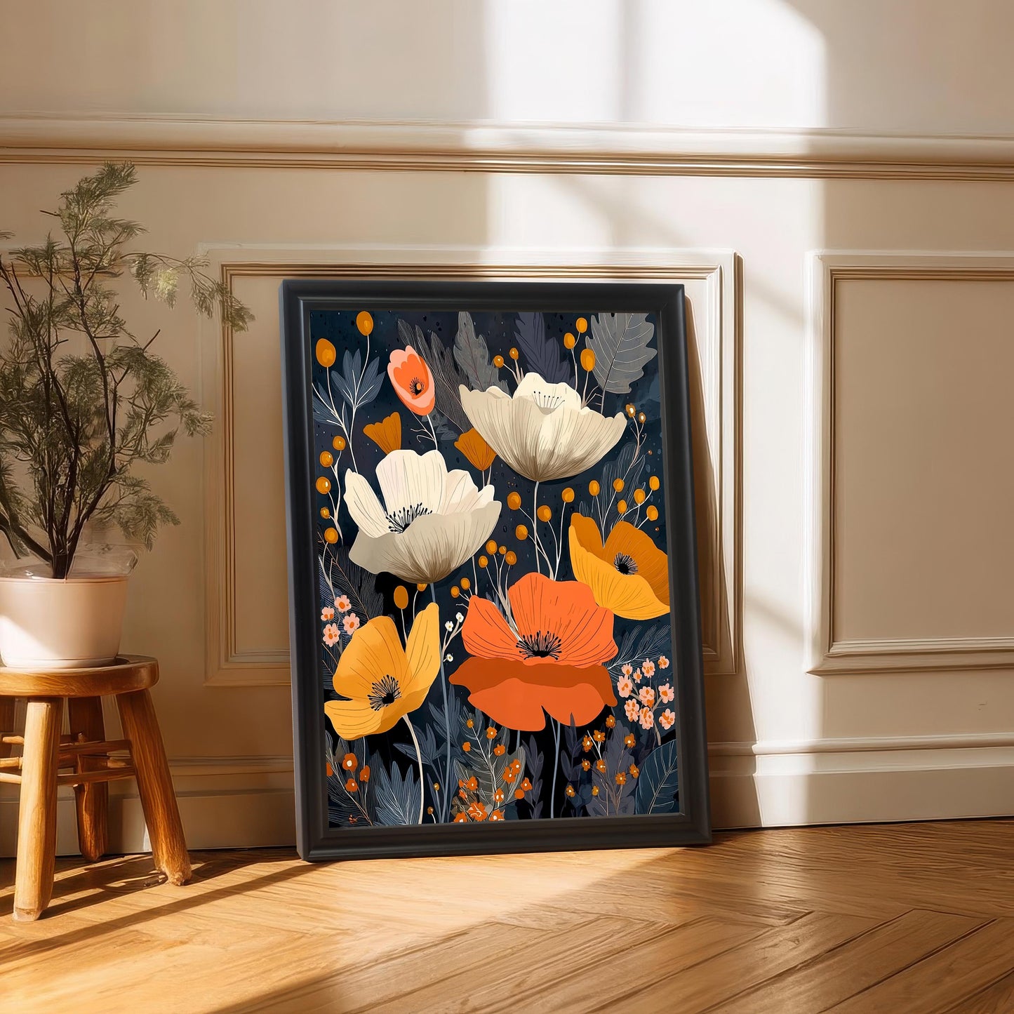 The abstract poppy artwork is leaning against a white paneled wall and dark wood floor. The frame is Black and does not include a mount (matting). A small potted plant on a wooden stool is in the foreground.