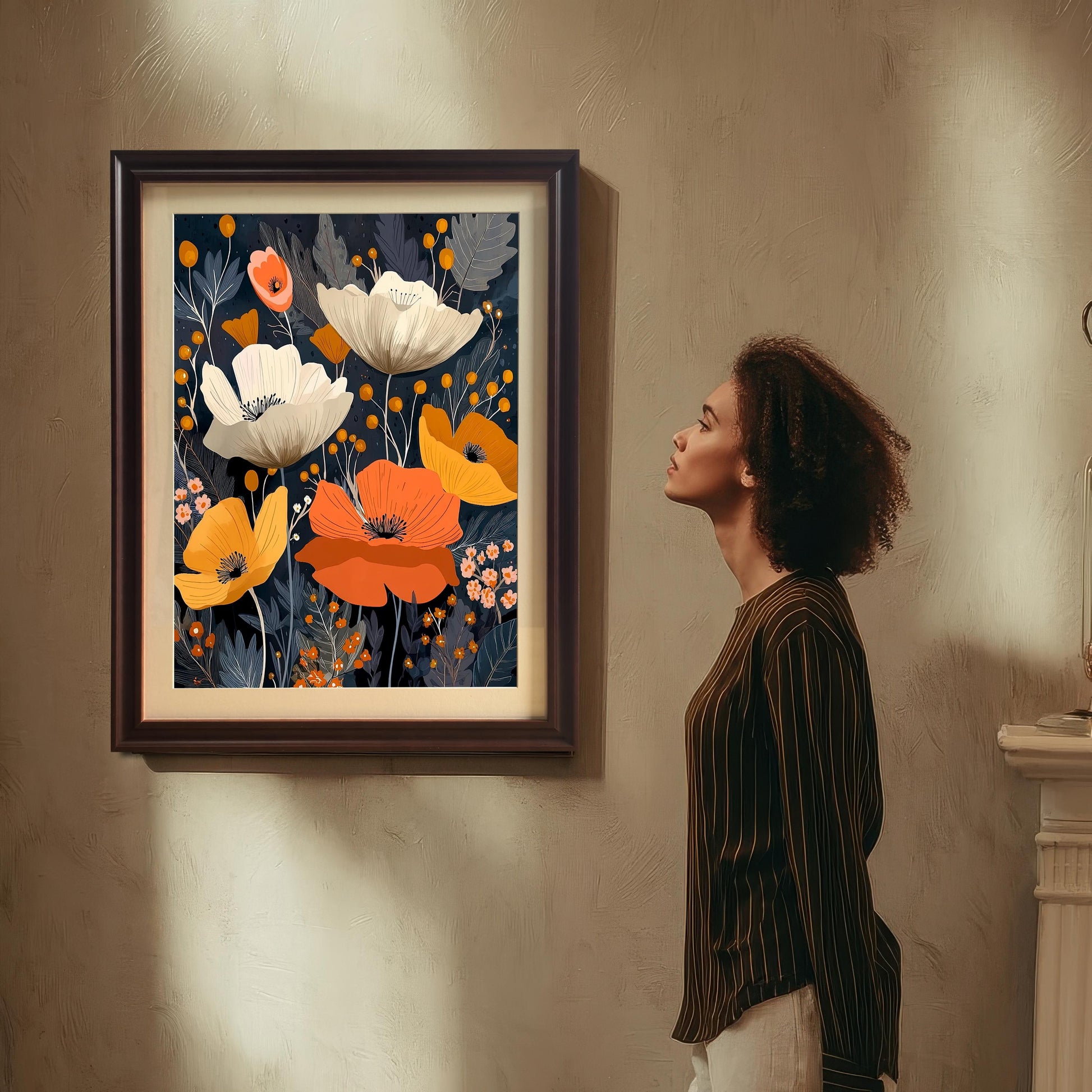 A woman with curly hair, wearing a striped shirt, stands looking up at the framed abstract poppy artwork hanging on a textured wall. The frame is Coffee/dark brown and includes a mount (matting).