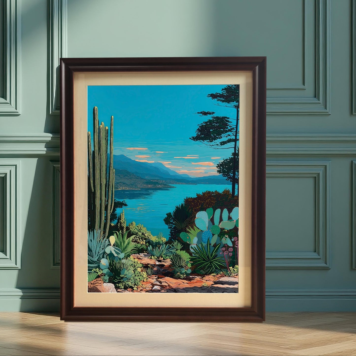The framed artwork, featuring a bright blue lake and desert landscape with cacti, is leaning against a stylish teal/green paneled wall. The frame is Coffee/dark brown and includes a mount (matting). Sunlight casts deep shadows on the wall.