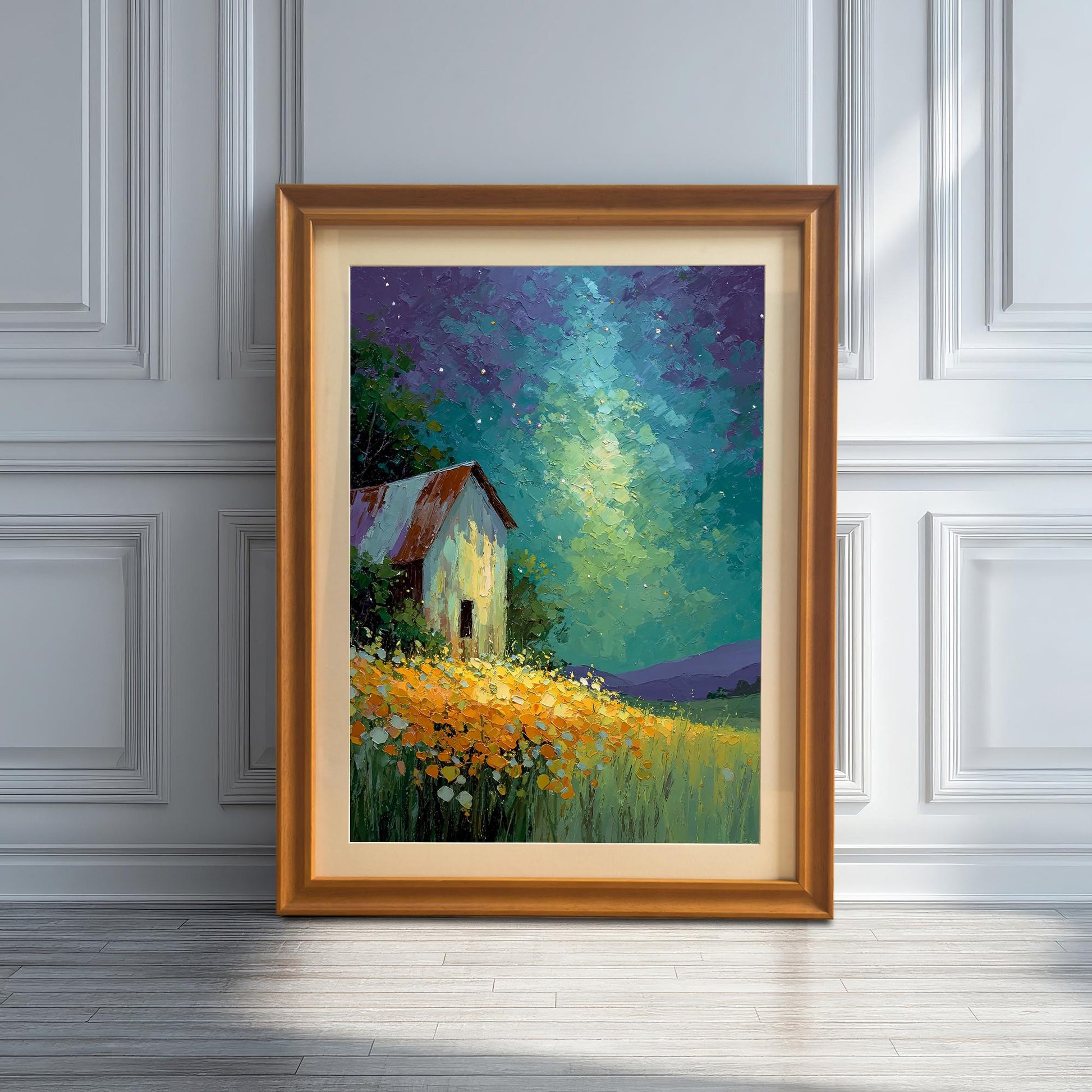 Artwork of a barn under a starry sky, framed in Orange wood with a mat, leaning on a wooden floor against a white paneled wall with strong sunlight and shadows.