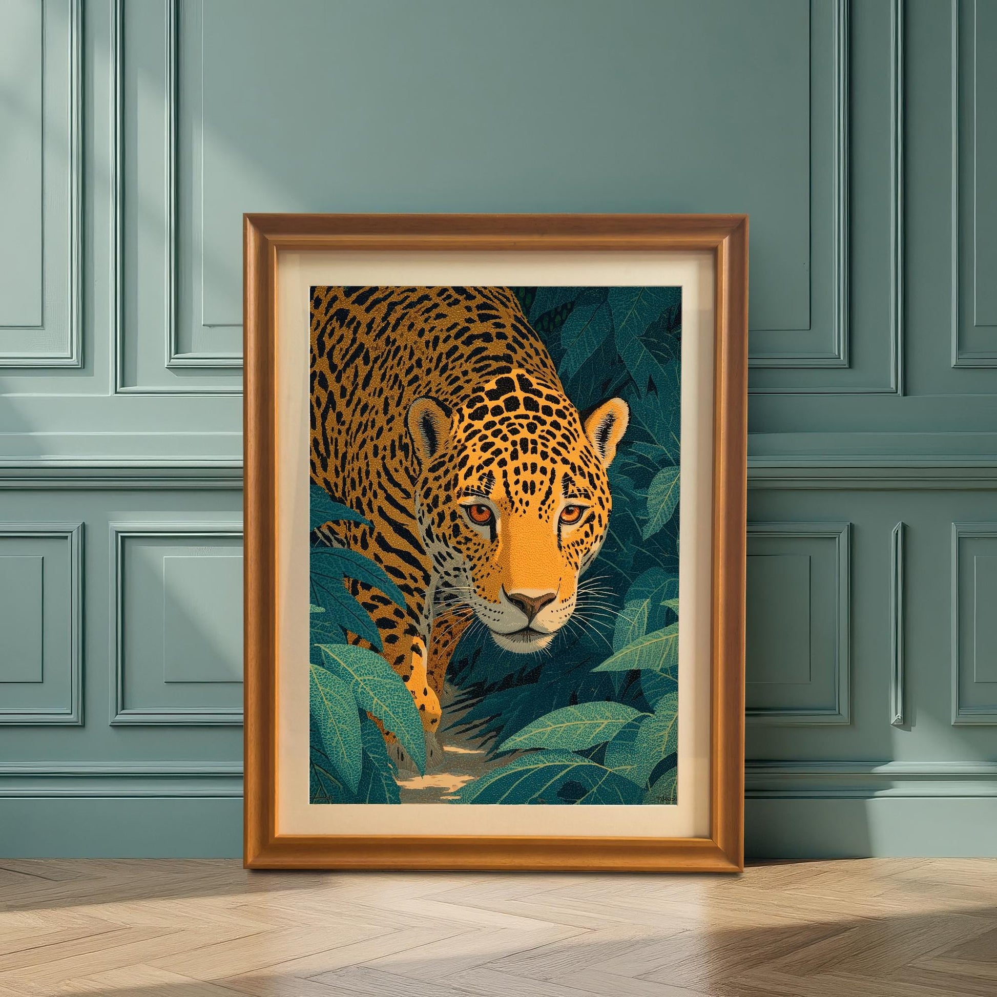 Framed artwork of a jaguar, with an Orange (gold) frame and mount. The large frame leans against a teal-paneled wall on a wood floor, illuminated by strong sunlight.