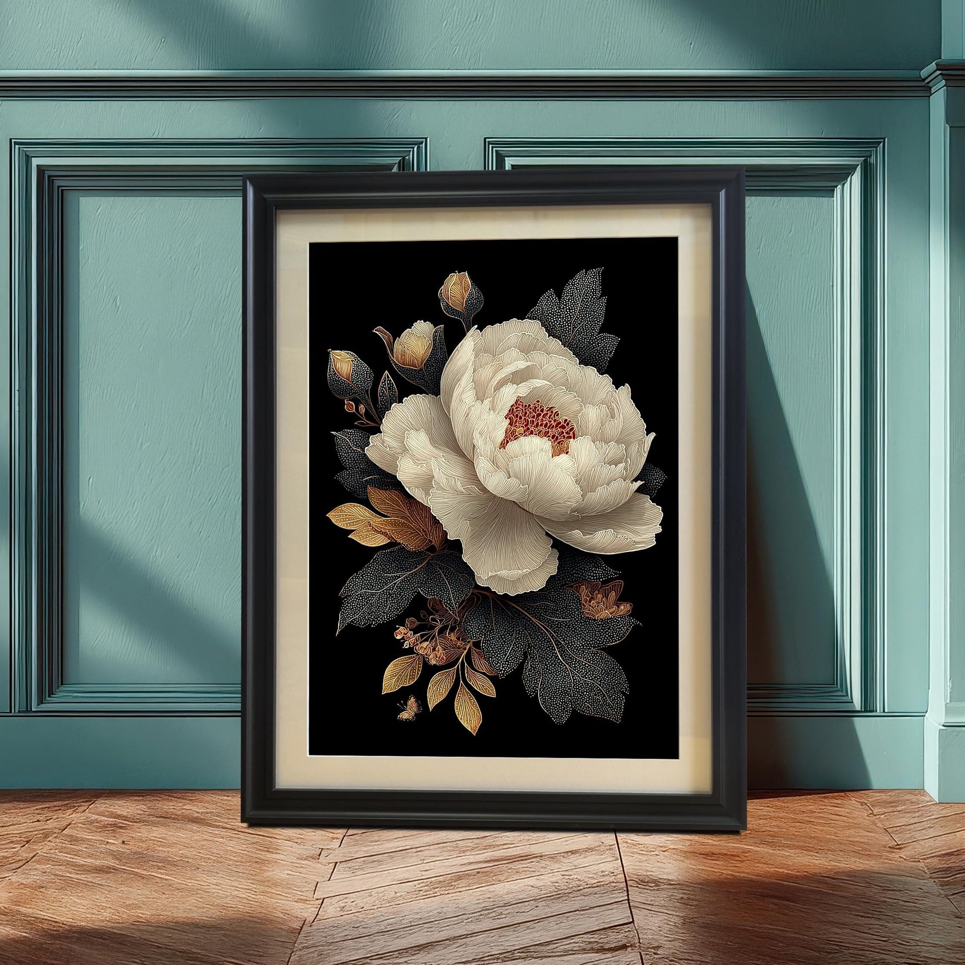 A framed print of a white peony with gold and dark foliage on a black background, leaning against a teal wainscoting wall. The frame is black and includes a visible light-colored mount (mat) bordering the print.
