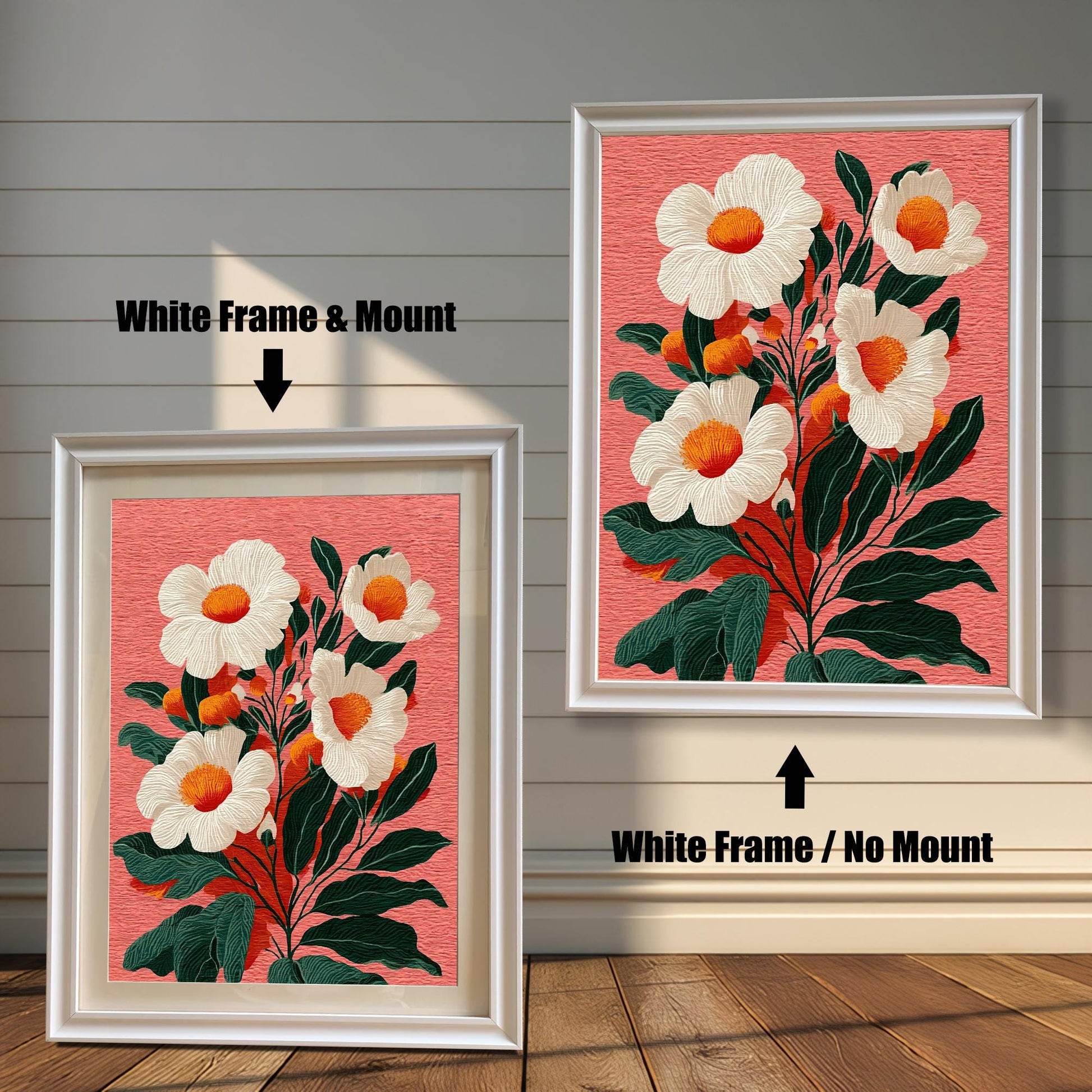 Two versions of a floral print against a rustic wooden wall. The print features white flowers with orange centers on a salmon-pink background. On the left, a framed print with a white frame and a mount. On the right, a framed print with a white frame and no mount.
