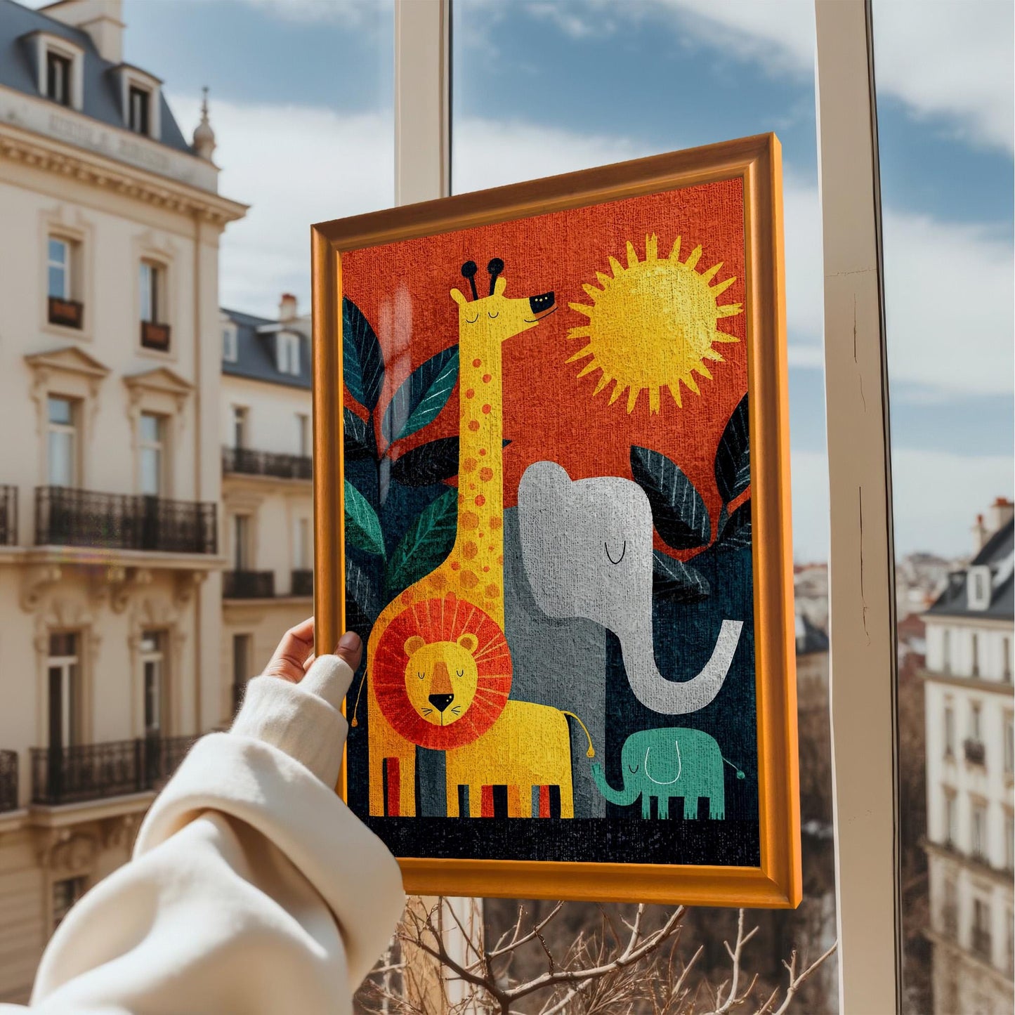 A person's hand holds up the framed jungle animal art print in an Orange/Gold frame against the backdrop of a sunny European cityscape from a window.