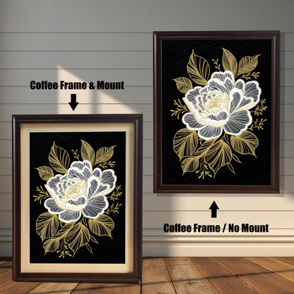 Two versions of the framed black and gold floral print against a distressed white wood background: one on the left in a Coffee Frame & Mount (with a light-colored border), and one on the right in a Coffee Frame / No Mount (without a border).