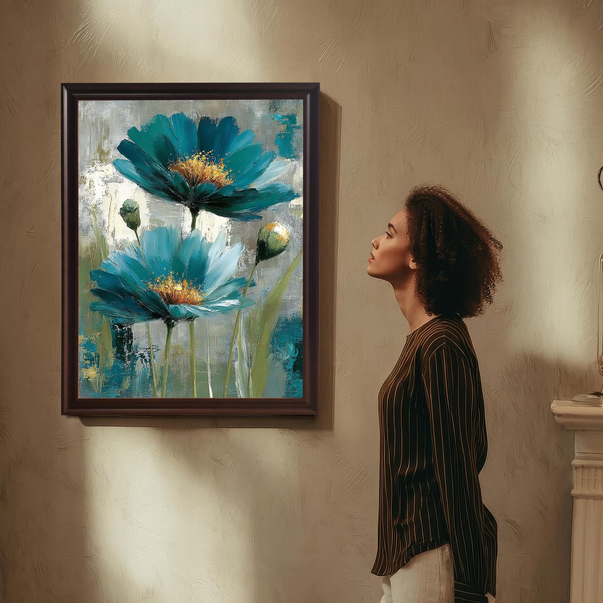 A woman in a striped shirt looks up at a framed art print hanging on a textured wall. The print is in a Coffee-colored wood frame with a mount and features the abstract teal and blue floral painting.