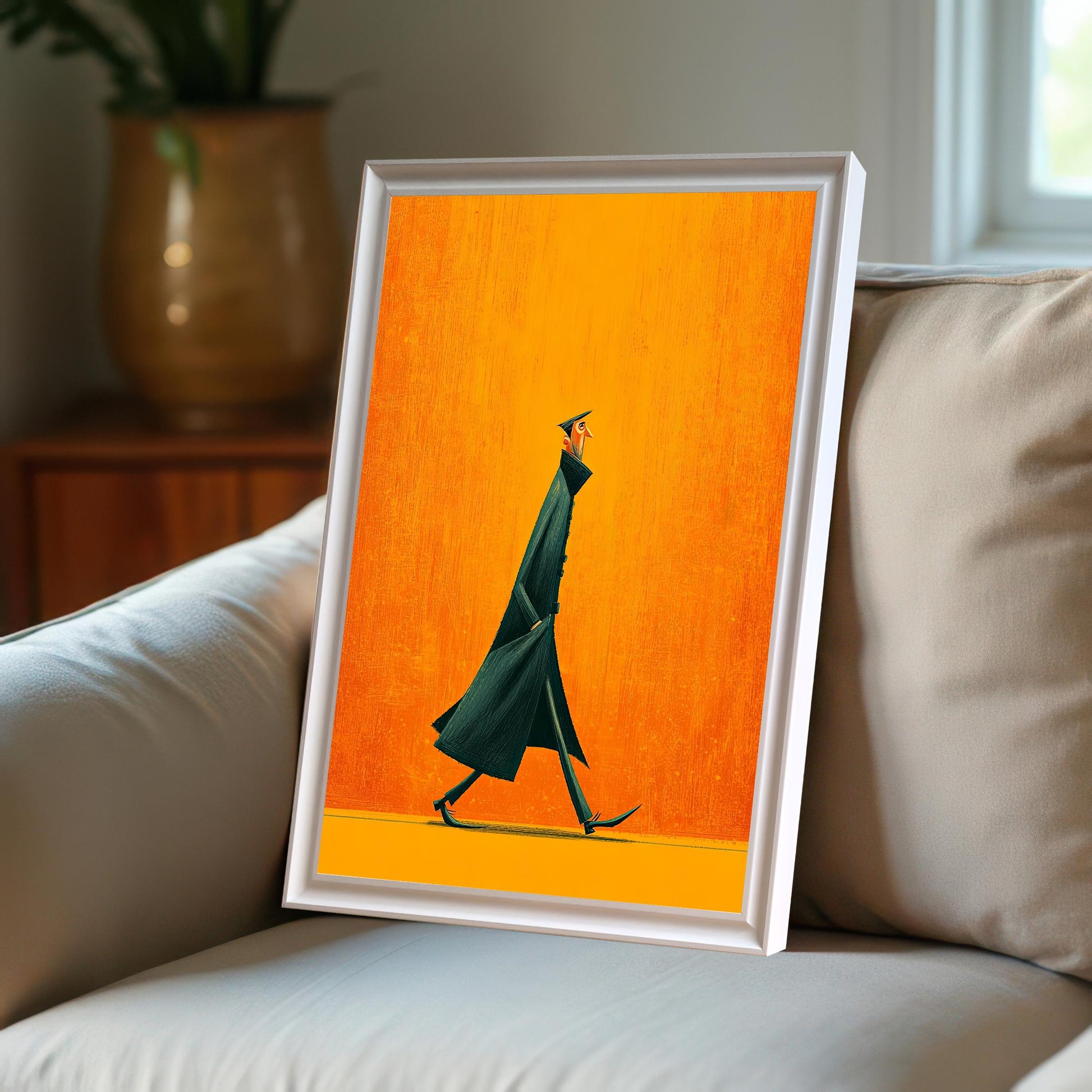 White framed art print displayed at an angle on a light-colored couch in a bright room, showcasing the white frame option in a lifestyle setting.