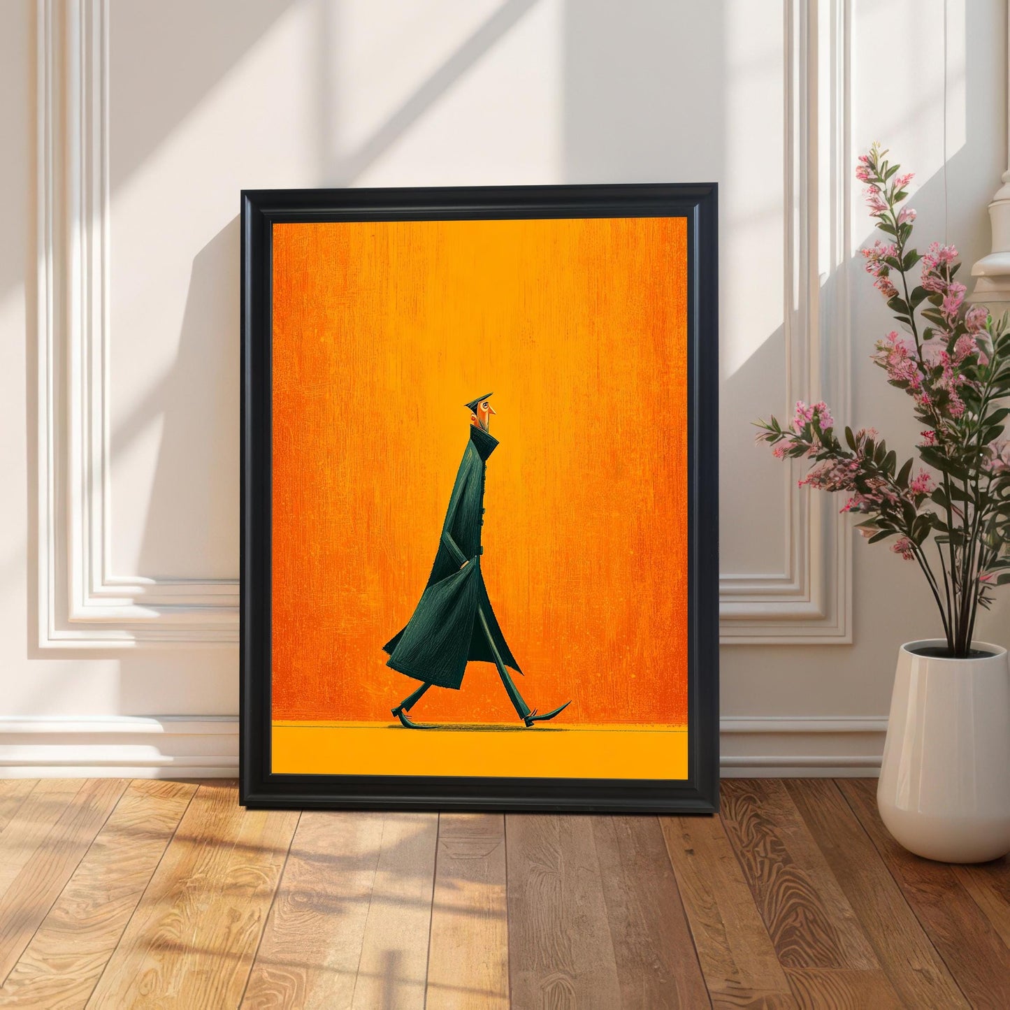 Large abstract art print of a figure in a dark coat against an orange background, framed in Black, leaning on a wood floor against a white wainscoting wall, with a pink floral plant beside it.