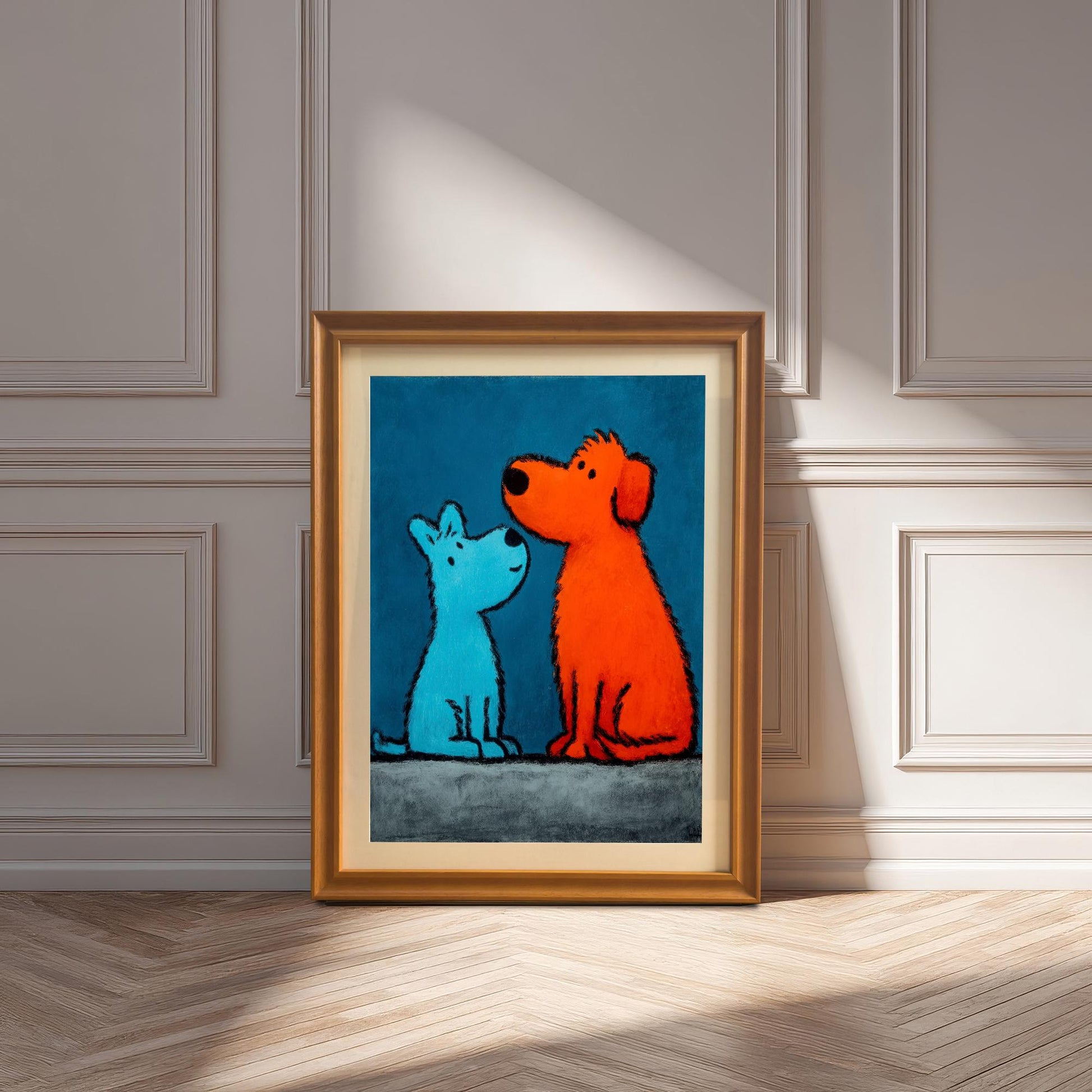 The framed pop art print of the blue and orange dogs with an Orange Frame (or Gold Tone Frame) and a mount (matting) leaning against a decorative paneled wall on a wood floor, with strong natural sunlight casting shadows.