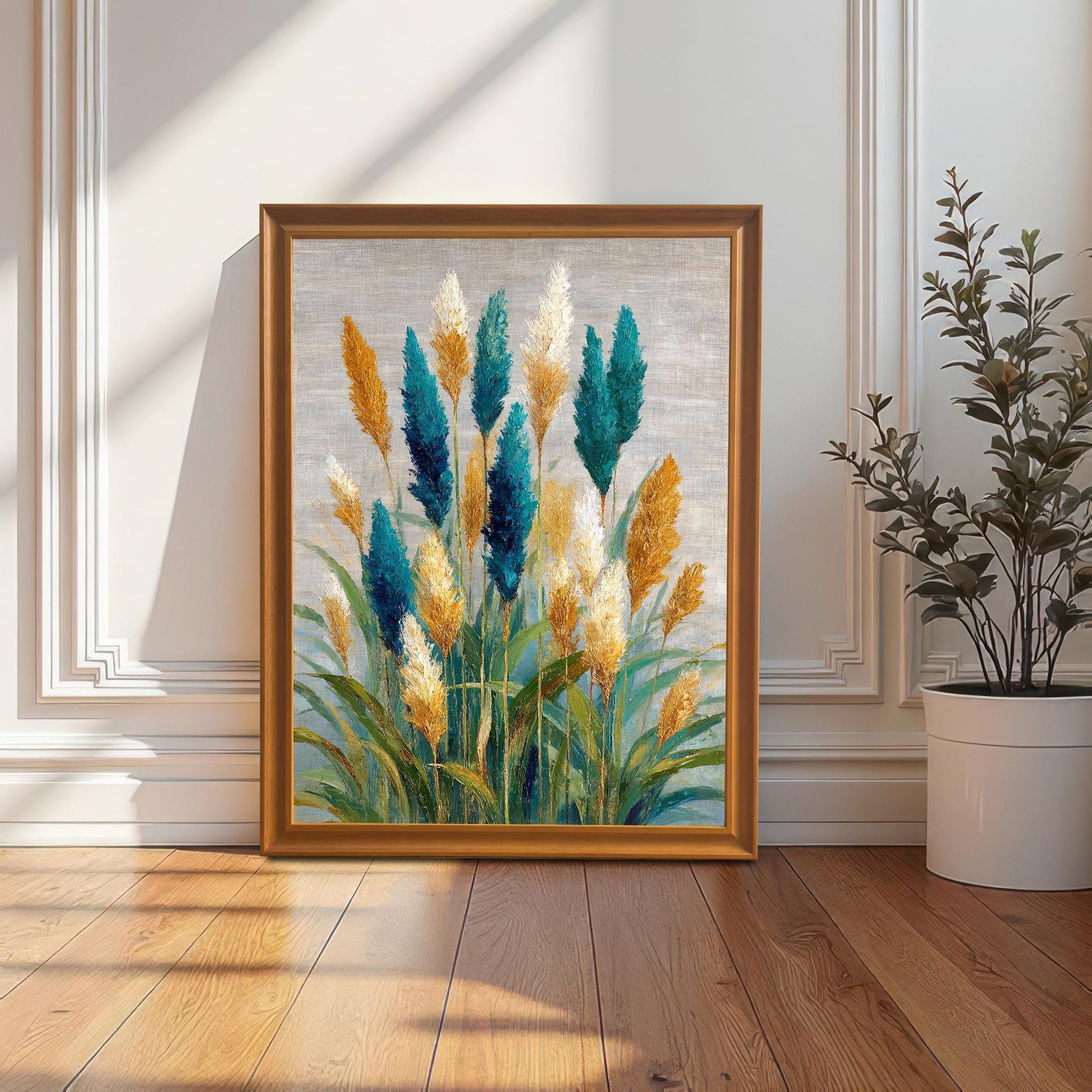 Teal and gold coastal grass abstract art print in an Orange wood frame, leaning on the floor against a classic white wainscot wall, next to a potted plant.