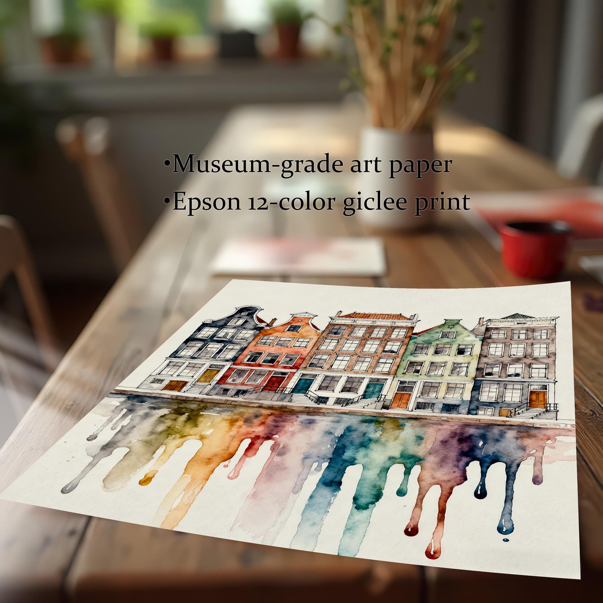 Close-up shot of the unframed watercolor print resting on a wooden table, emphasizing the house details and dripping paint reflection. Text overlay reads: "Museum-grade art paper" and "Epson 12-color giclee print".