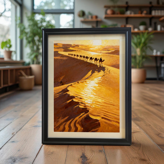 The desert camel caravan art print in a Black Frame with a Mount (mat), standing upright on a polished wooden floor. The background is a bright, modern room filled with indoor plants, giving a bohemian or nature-inspired decor vibe.